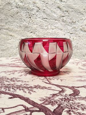 a red and white bowl sitting on top of a table