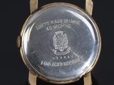 an image of a close up of a watch on a black surface