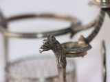 a silver horse head on top of a glass holder