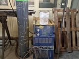 a green fire hydrant sitting next to a stack of pallets