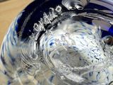 a blue and white bowl filled with water on a table