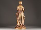 statue of a woman holding a flower in her right hand