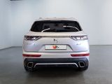 the rear end of a white suv parked in a garage