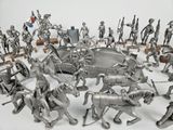 silver figurines of knights and horses in a circle on a table