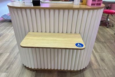 a small bar with a wooden bench in the middle of the room