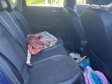 the back seat of a car with a bunch of items in it