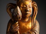 an image of a statue of a person holding a bird