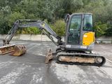 a small excavator that is parked in a parking lot
