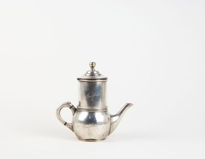 an old silver teapot with a handle on a white background
