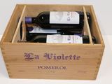 two bottles of wine in a wooden box on a table