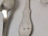 two spoons and a spoon with a face on them