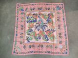 an old pink and blue paisley square scarf on a grey floor