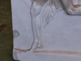 a statue of a woman holding a vase in her hand