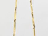 a gold necklace with a long chain and a clasp