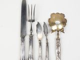 a silver plate with a knife, fork, and spoon on it