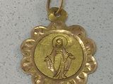 gold plated medal with the image of the virgin of guadalupe on it