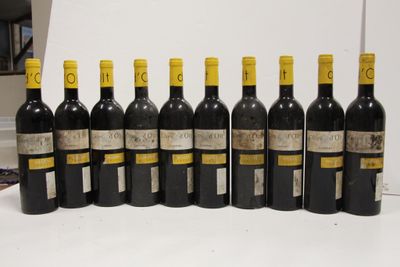 several bottles of wine are lined up on a table