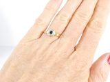 a woman ' s hand with a red manicure and a ring on it