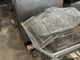 a metal cart with a basket on top of it in a warehouse