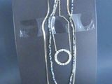 a necklace and a bracelet on display in a display case