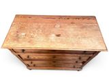 a small wooden chest of drawers on a white background