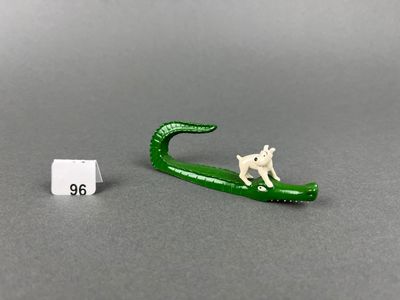 miniature figurine of a cat sitting on a leaf next to a sign