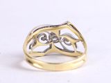 an image of a gold and silver ring on a white surface