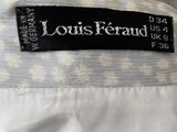 the label of a louis feraud dress is shown on the back of a white shirt