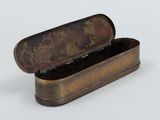 an old metal box with a lid on a white surface