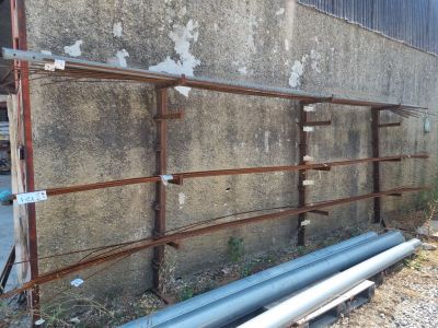 a wall with a bunch of pipes on it next to a building