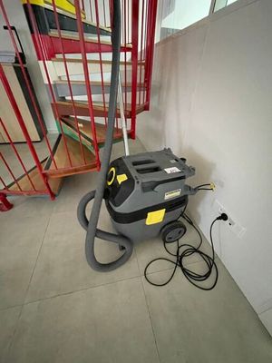 a vacuum that is sitting on the floor next to the stairs