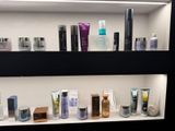 many different types of skin care products displayed on the shelves