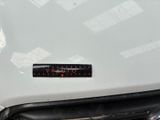 a sticker on the hood of a white car