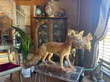 a statue of a dog on a table in a living room