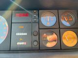 a close up of a car dashboard with various gauges