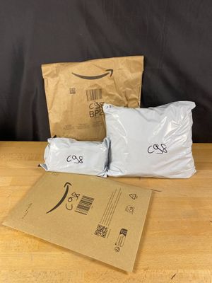 three bags of food sitting on top of a wooden table next to a brown bag