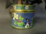a plant in a pot with a bird on top of it