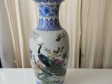 a blue and white vase sitting on a white table