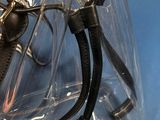 a clear plastic bag with a pair of scissors inside of it