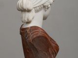marble bust of a woman with braid hair on a table