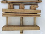 a wooden rack with tools on it on the wall