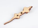 a close up of a wooden object on a white surface
