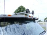 a white truck with a horn on top of it