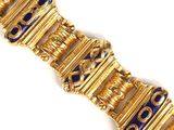 an image of a gold bracelet with blue glass beads on it
