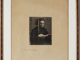 a black and white photo of a man holding a book