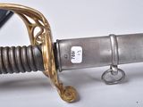 a close up of a sword on a white surface