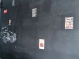 a blackboard with stickers on it in the corner of a room