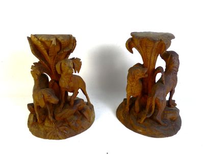 two wooden vases with animals on them on a white surface