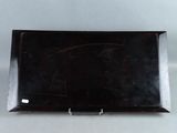 an image of a black tray with writing on it sitting on a table