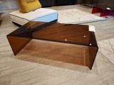 a glass coffee table on the floor in a living room